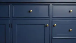 Freshly painted navy blue kitchen cabinets with brass hardware showcasing cabinet painting vs cabinet refacing results